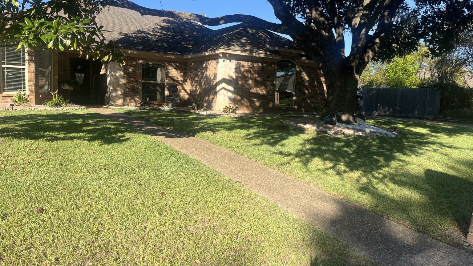 Freshly mowed residential front lawn and landscaped yard