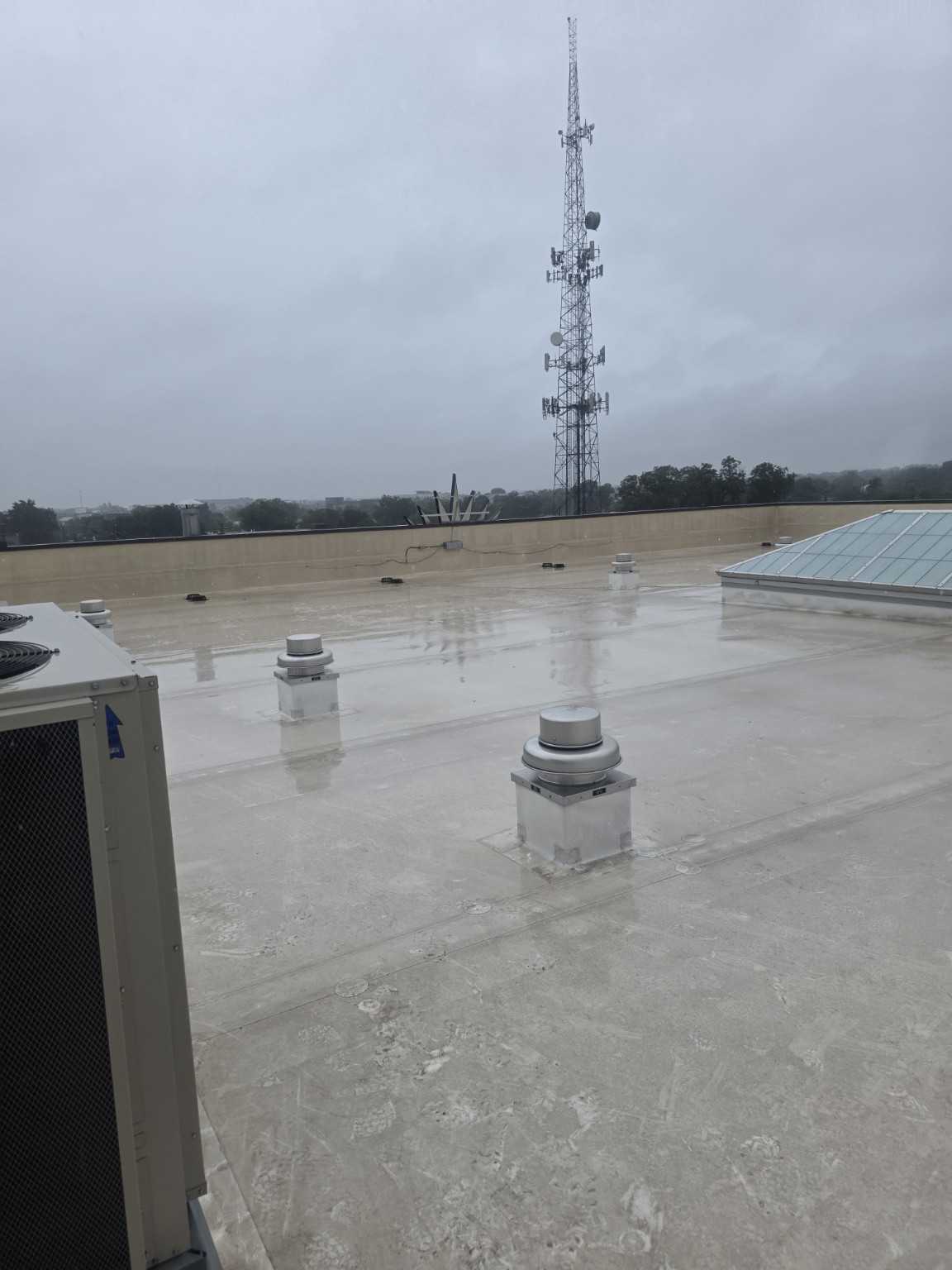 Commercial flat roof with rooftop equipment and skylight